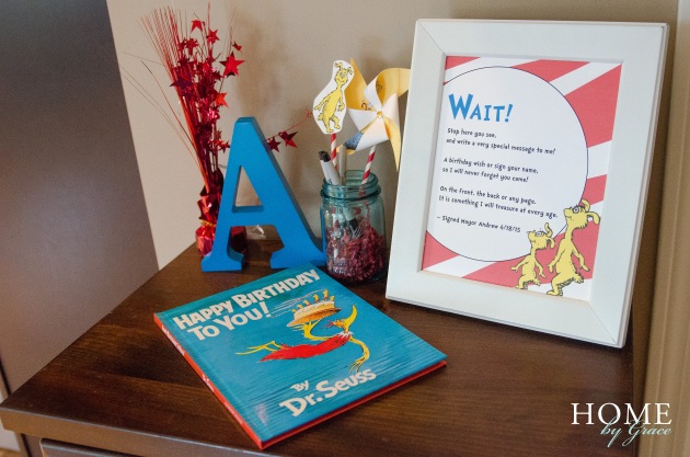dr seuss birthday party decorations in kitchen dining area with birthday sign and happy birthday to you book